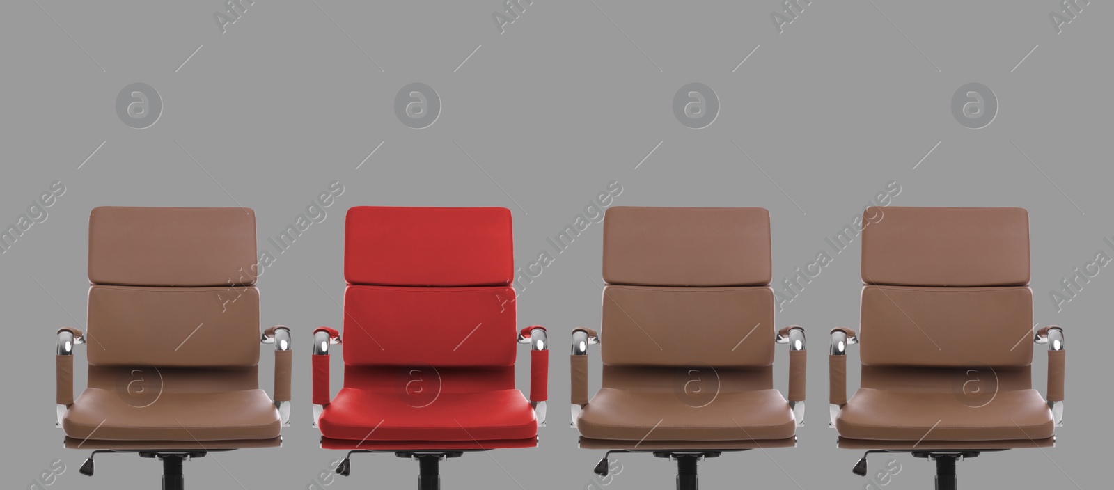 Image of Vacant position. Red office chair among brown ones on grey background, banner design