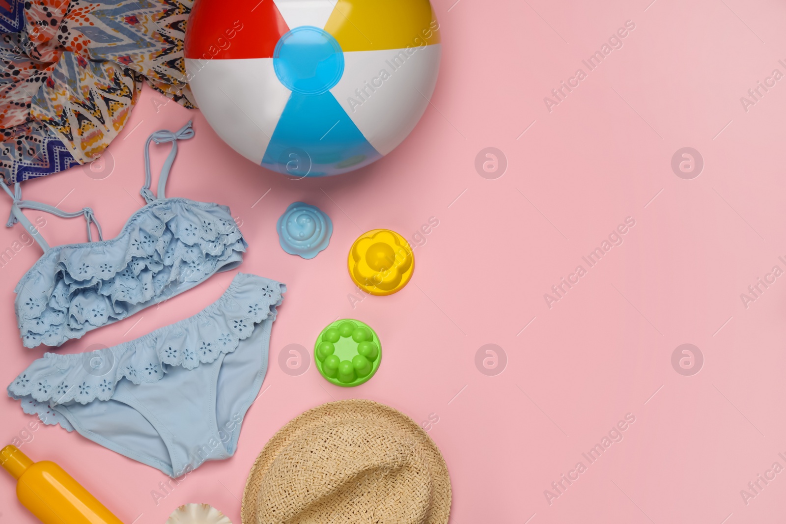 Photo of Flat lay composition with beach ball on pink background. Space for text