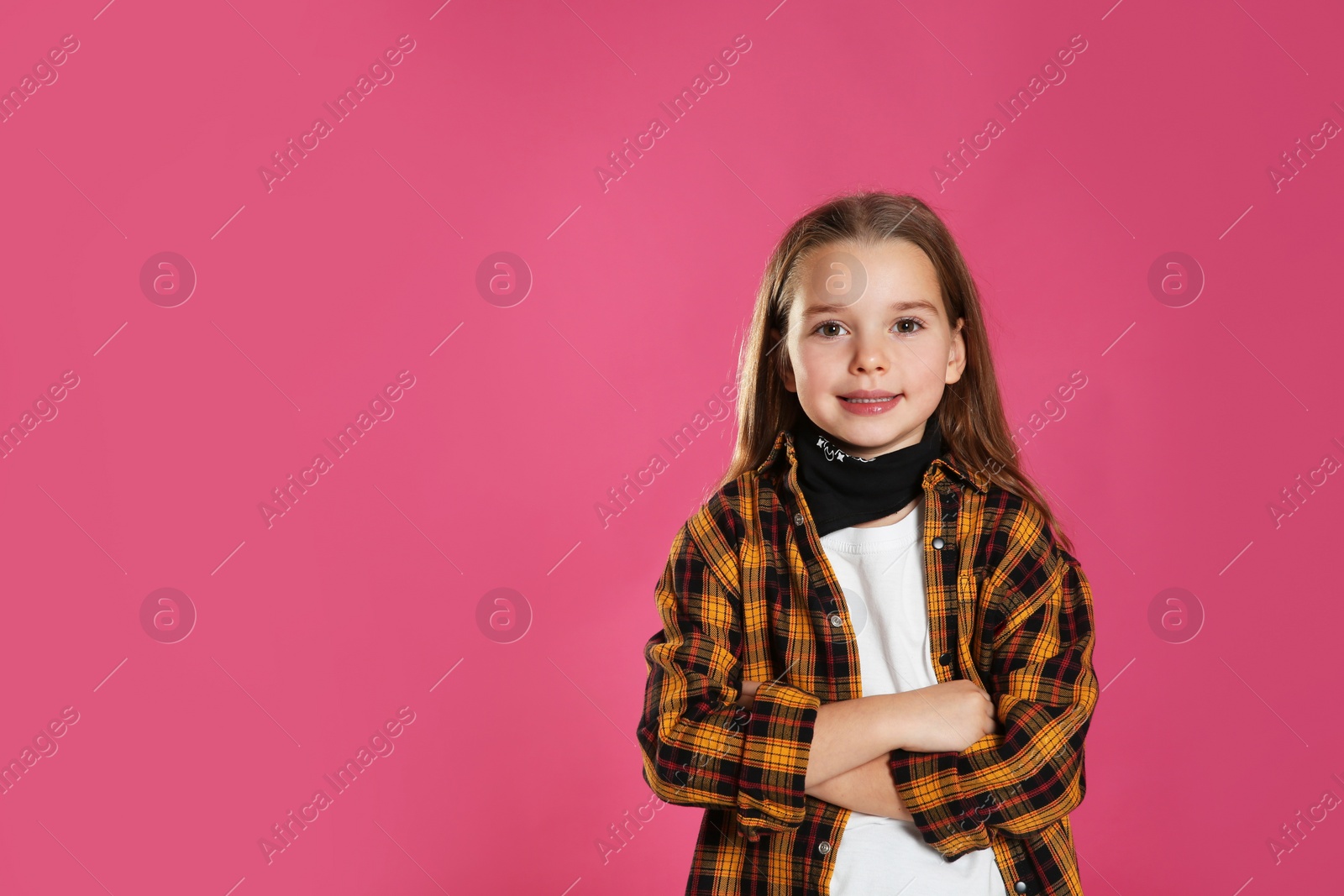 Photo of Cute little girl wearing stylish bandana on pink background, space for text