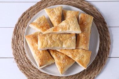 Delicious puff pastry on white wooden table, top view