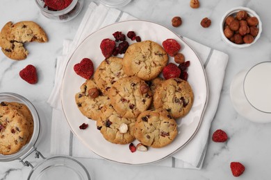 Photo of Cookies with freeze dried fruits and nuts on white marble table, flat lay