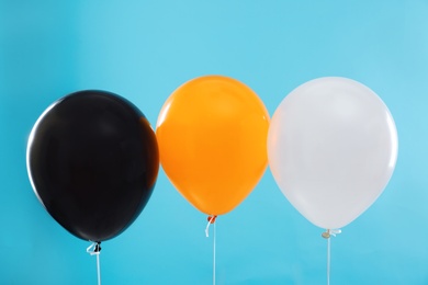 Colorful balloons on blue background. Halloween party