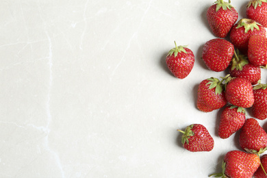 Photo of Delicious ripe strawberries on light grey marble table, flat lay. Space for text