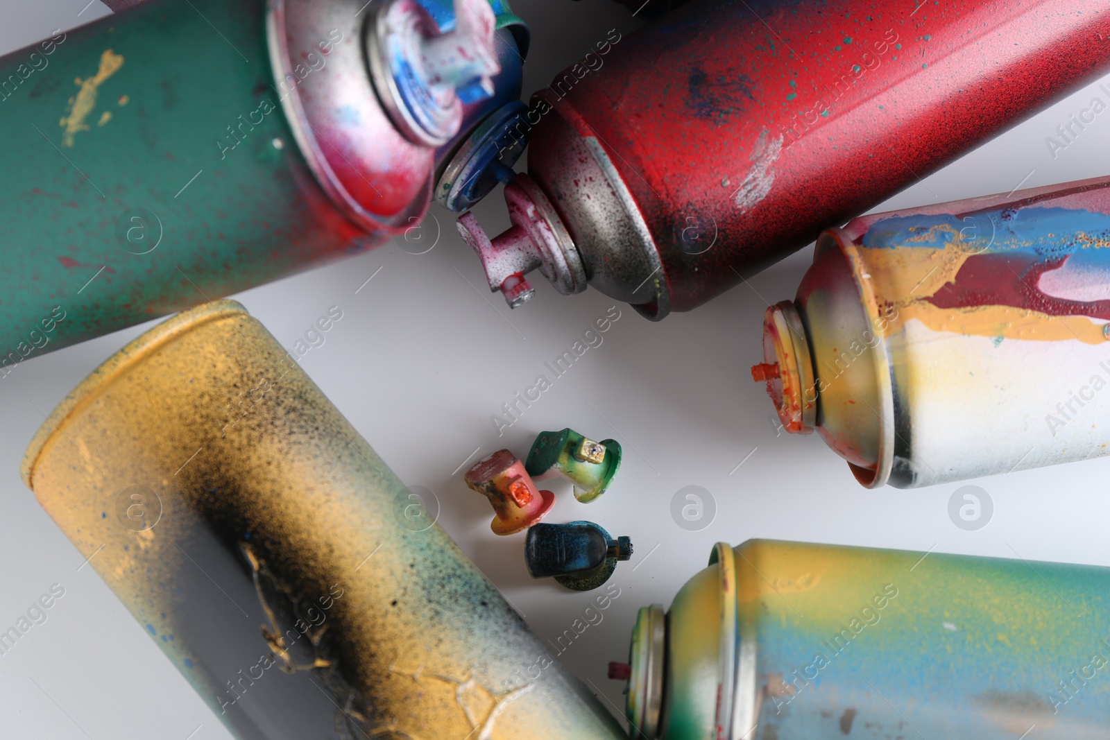 Photo of Many spray paint cans on white background, flat lay