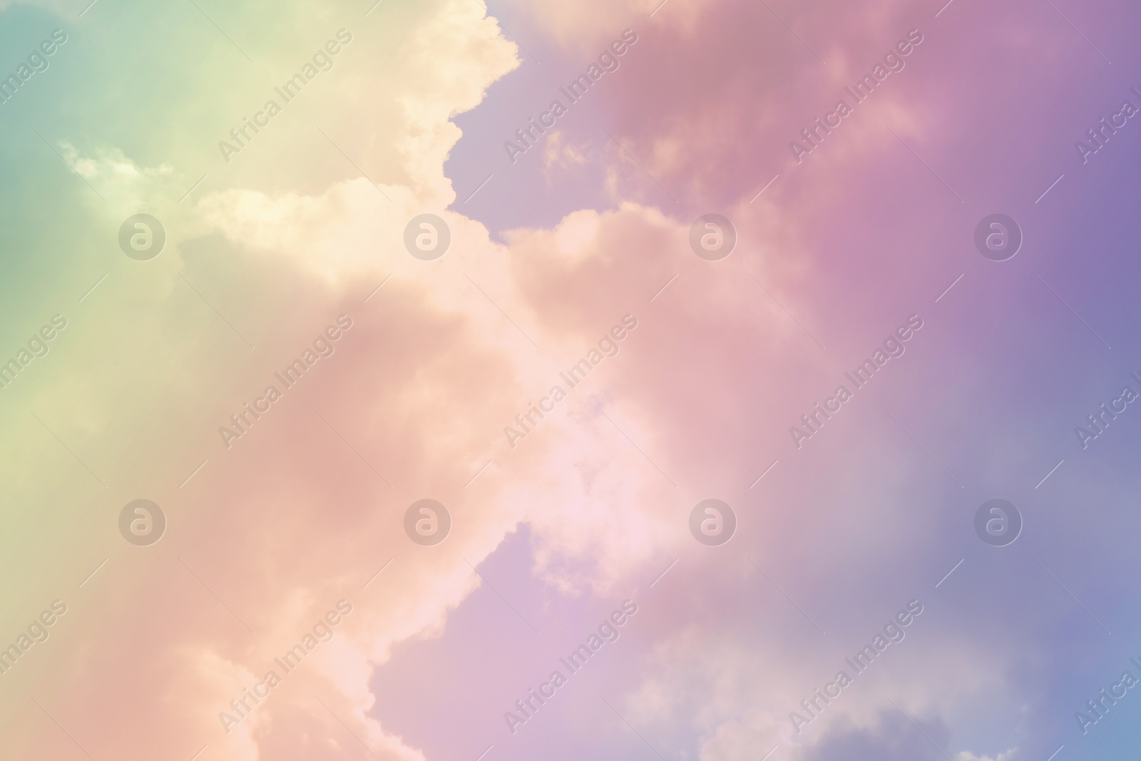 Image of Fantasy world. Picturesque view of beautiful magic sky with fluffy clouds, toned in pastel rainbow or unicorn colors