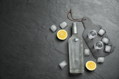 Photo of Flat lay composition with cold Russian vodka on black table. Space for text