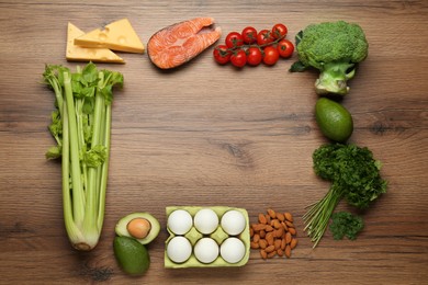 Photo of Frame of fresh organic products on wooden table, flat lay with  pace for text. Keto diet