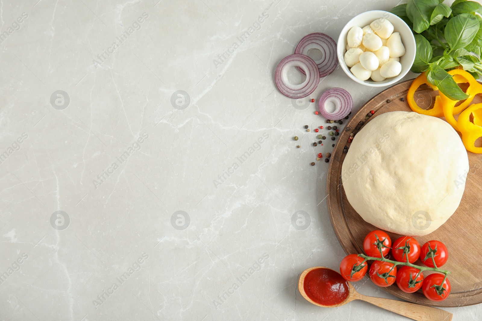 Photo of Flat lay composition with dough and ingredients for pizza on marble table, space for text