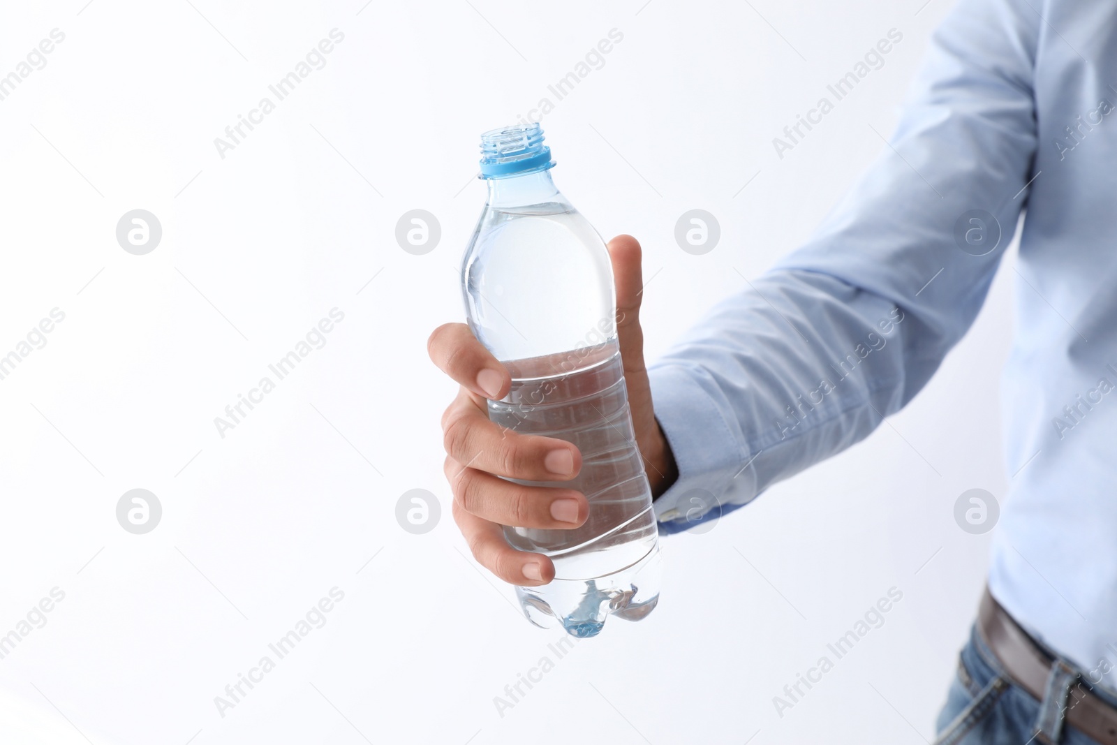 Photo of Man holding bottle of pure water on white background, closeup. Space for text