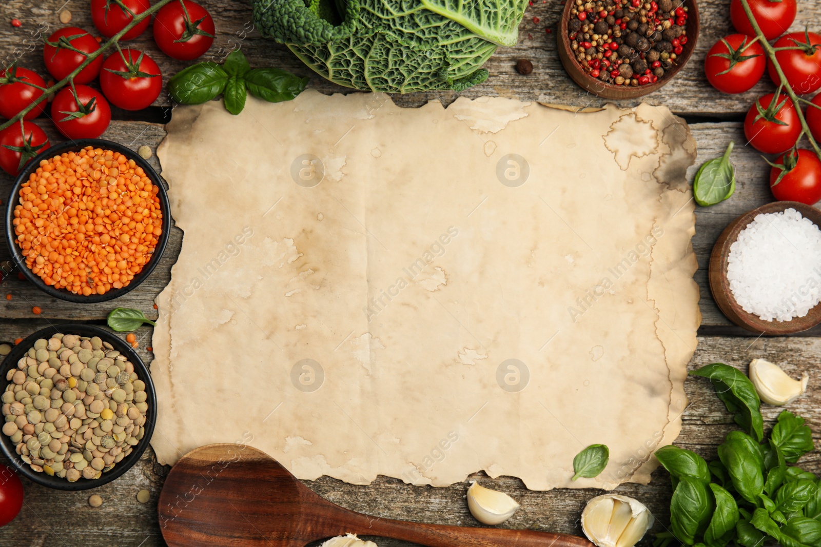 Photo of Parchment surrounded by different ingredients on wooden table, flat lay with space for text. Cooking classes