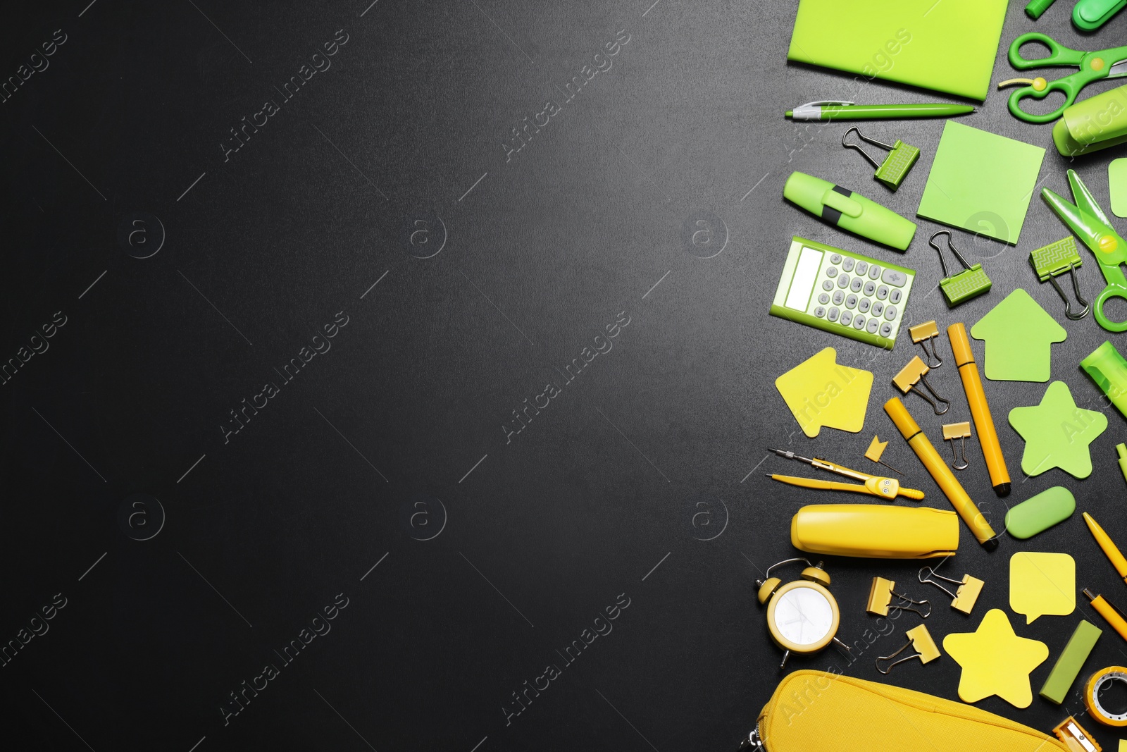 Photo of Flat lay composition with school stationery on black chalkboard, space for text