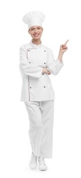 Photo of Happy woman chef in uniform pointing at something on white background