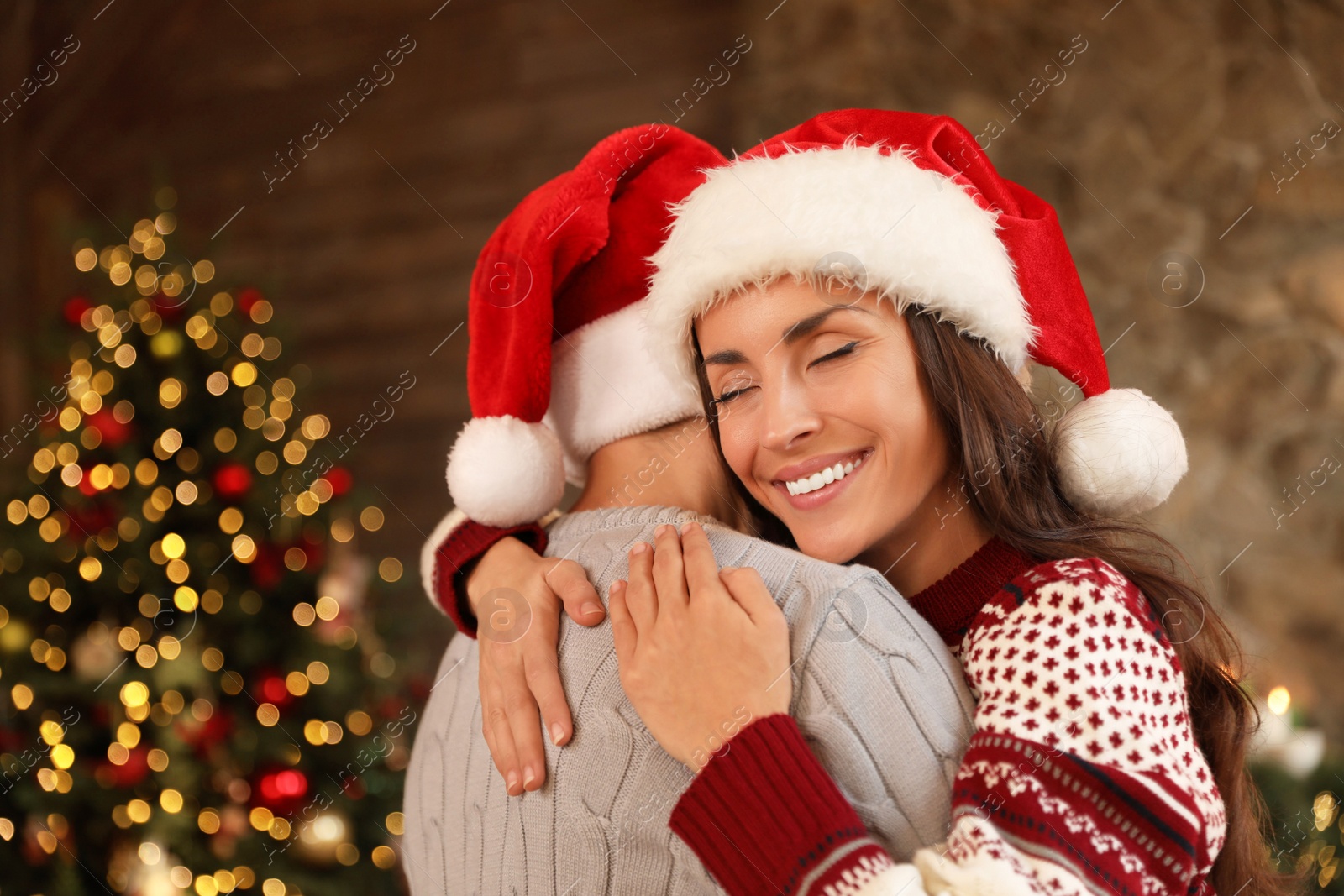 Photo of Happy young couple hugging at home. Christmas celebration