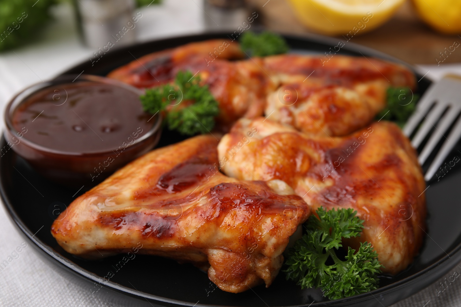 Photo of Fresh marinade and chicken wings on table, closeup