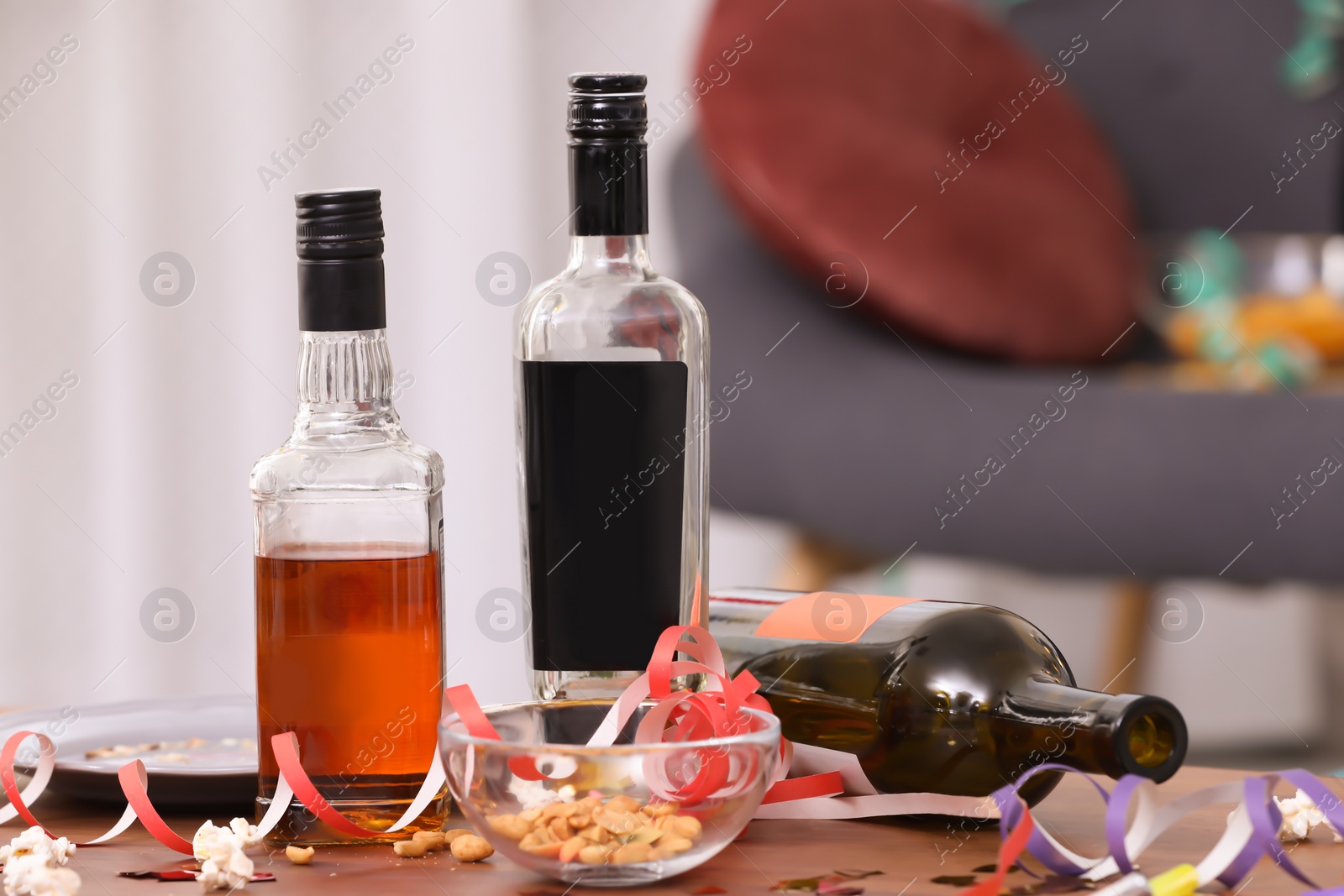 Photo of Messy table with bottles after party indoors, closeup