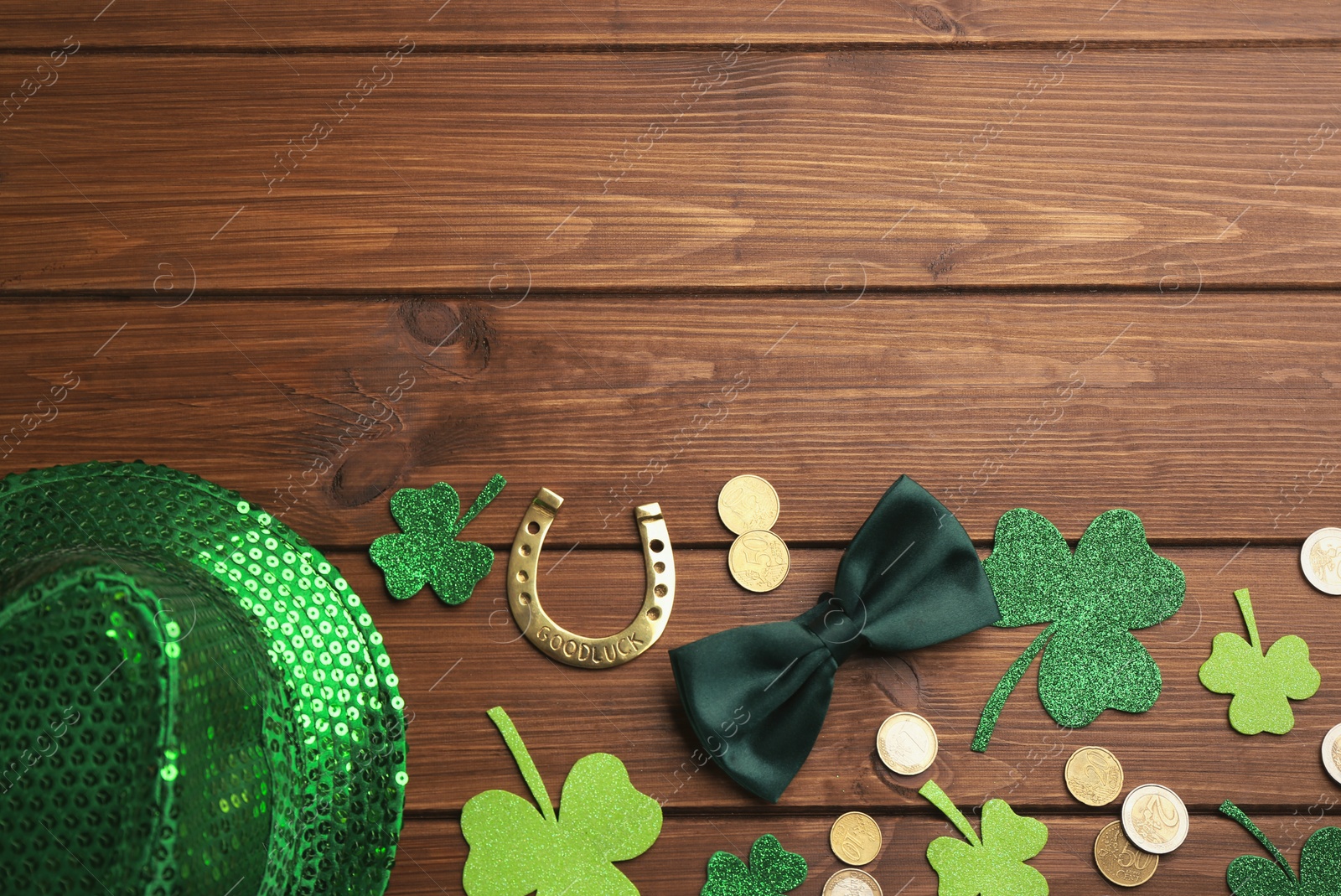 Photo of Flat lay composition with leprechaun hat on wooden table, space for text. St Patrick's Day celebration