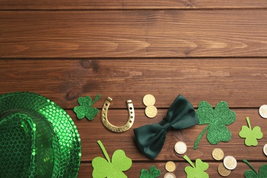 Flat lay composition with leprechaun hat on wooden table, space for text. St Patrick's Day celebration