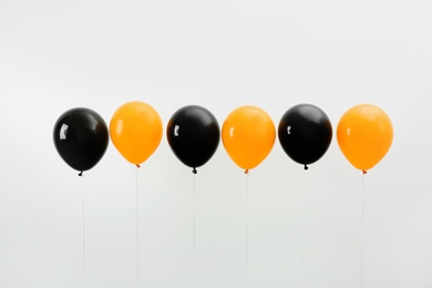 Photo of Colorful balloons on light background. Halloween party