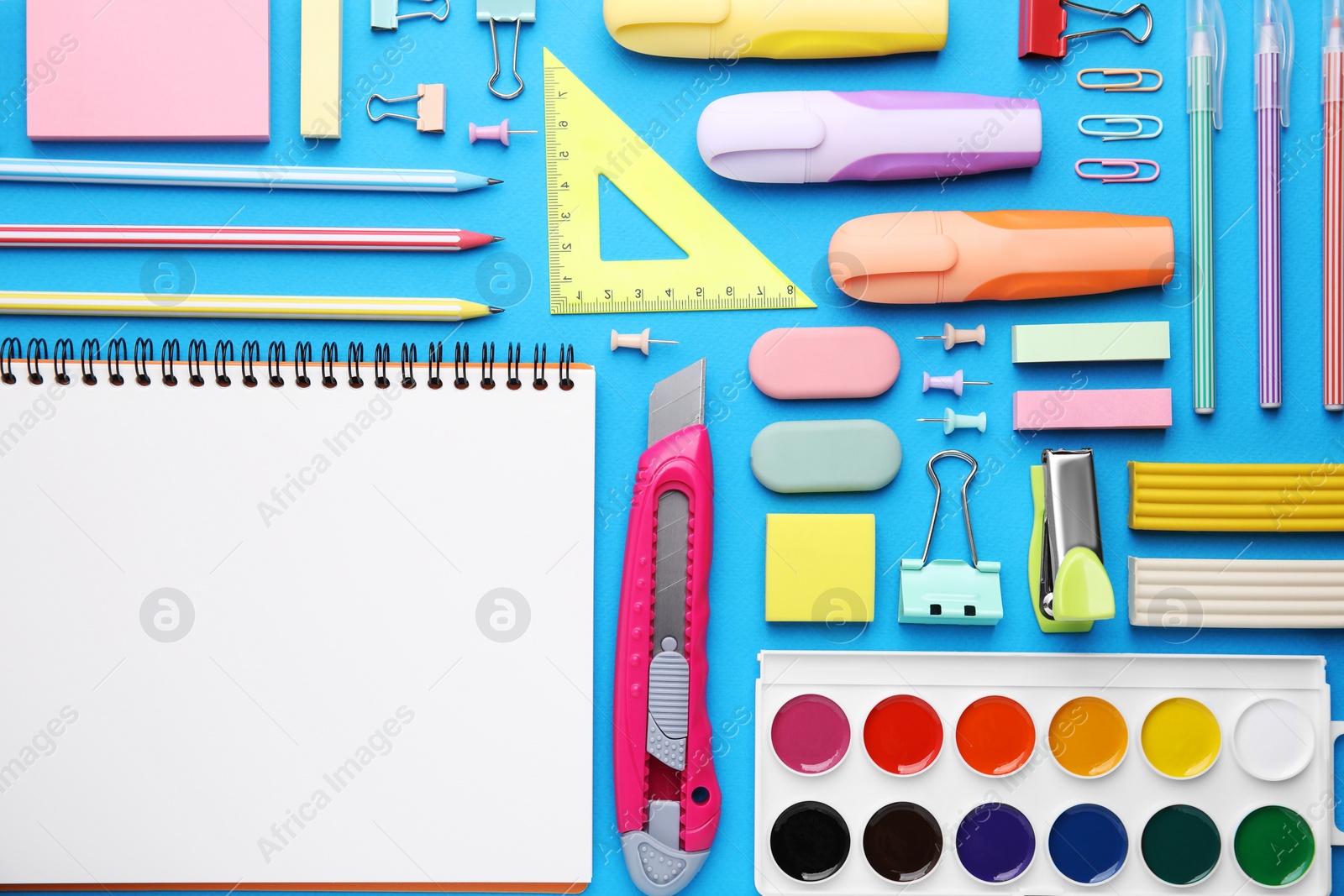 Photo of Different school stationery on light blue background, flat lay. Back to school