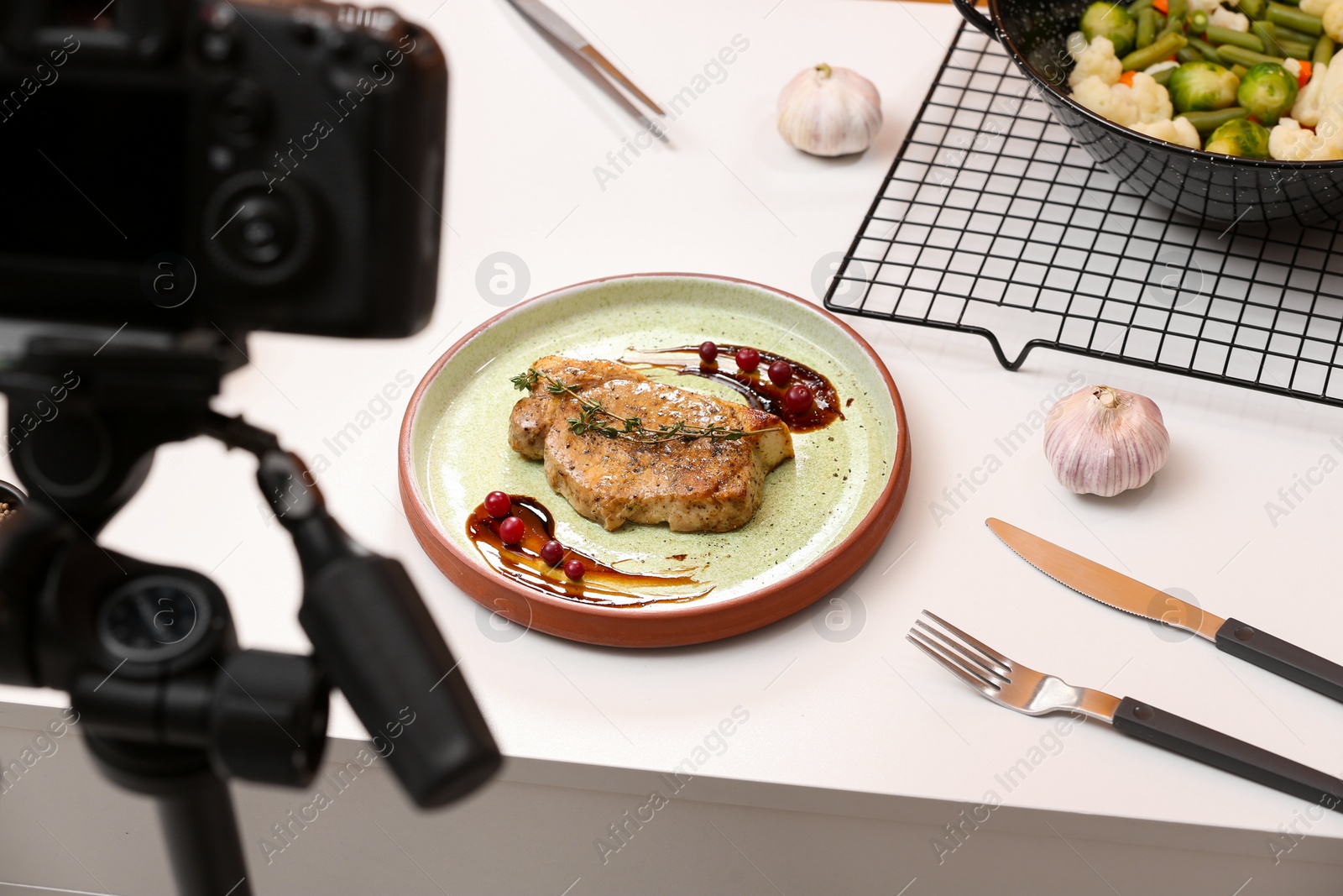 Photo of Food photography. Professional camera and composition with delicious meat medallion on white table in studio