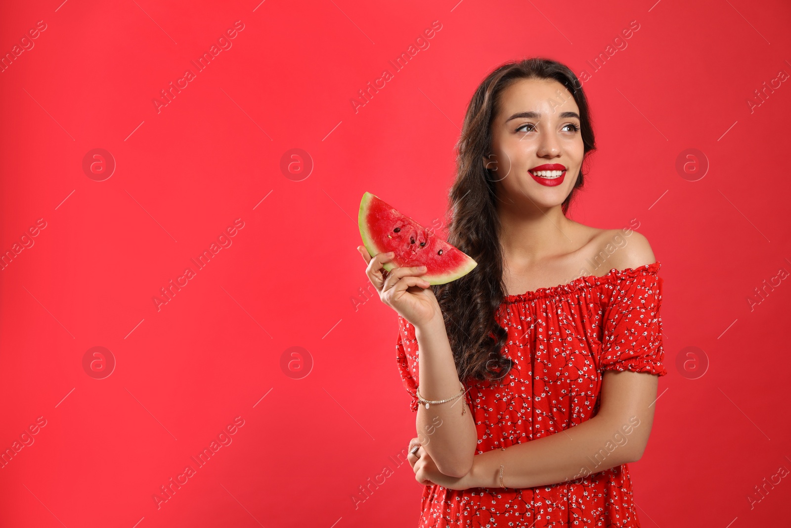 Photo of Beautiful young woman with watermelon on red background. Space for text