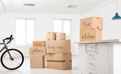 Cardboard boxes and bicycle indoors. Moving day