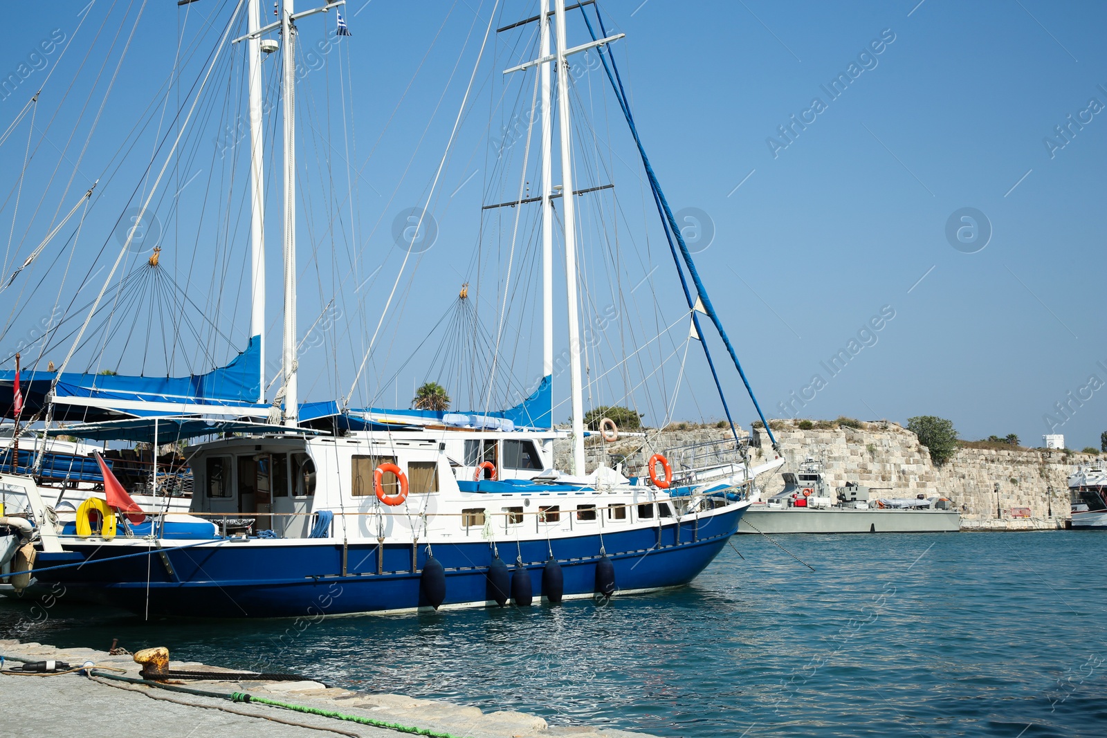 Photo of Beautiful view of sea port with moored boats and ship on sunny day