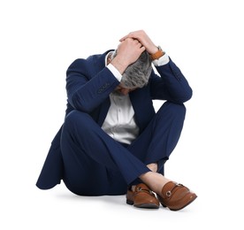 Photo of Mature businessman in stylish clothes sitting on white background