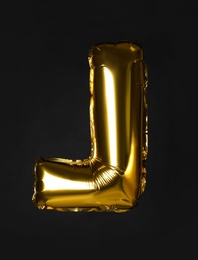 Golden letter L balloon on black background