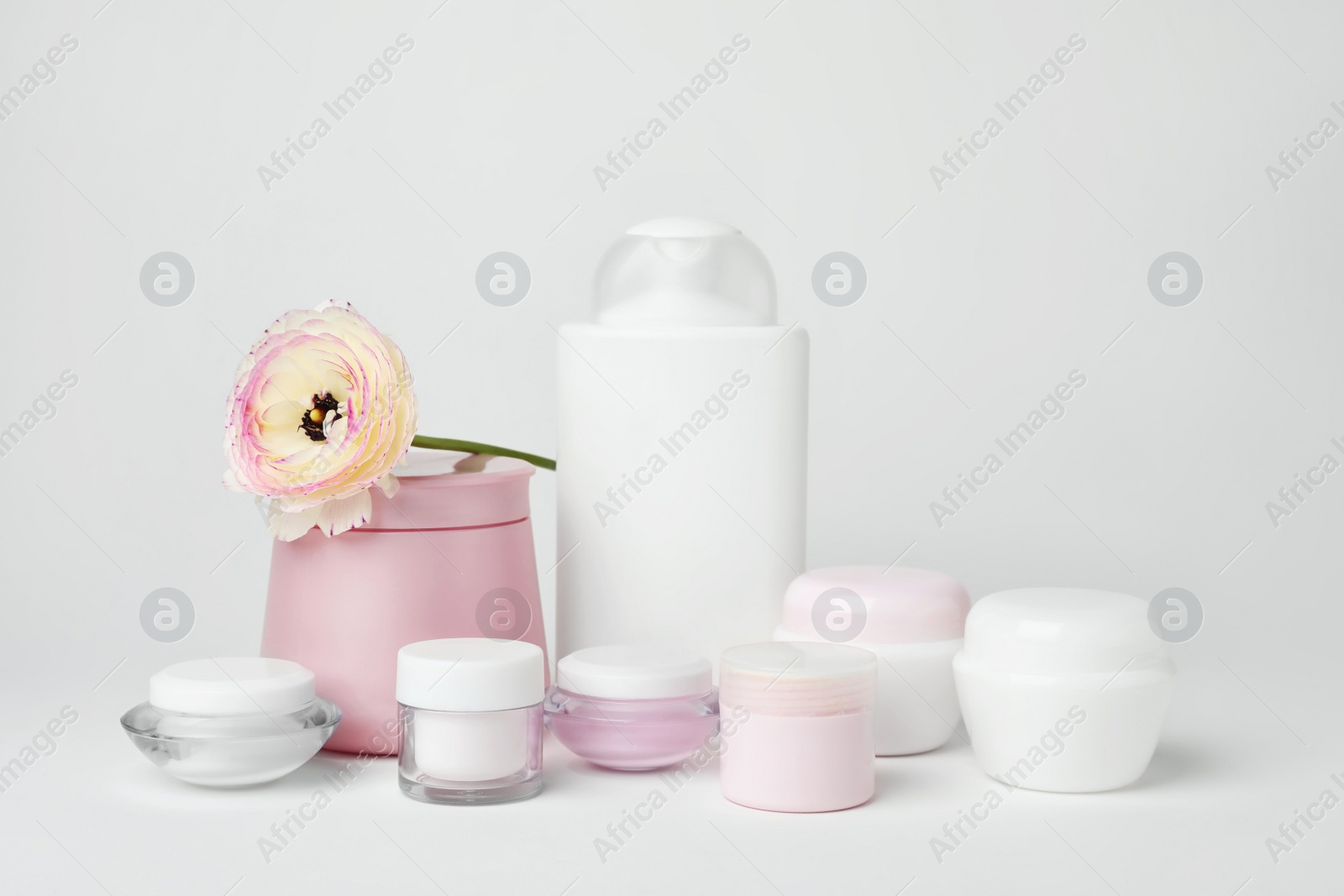 Photo of Composition with cosmetic products on light background