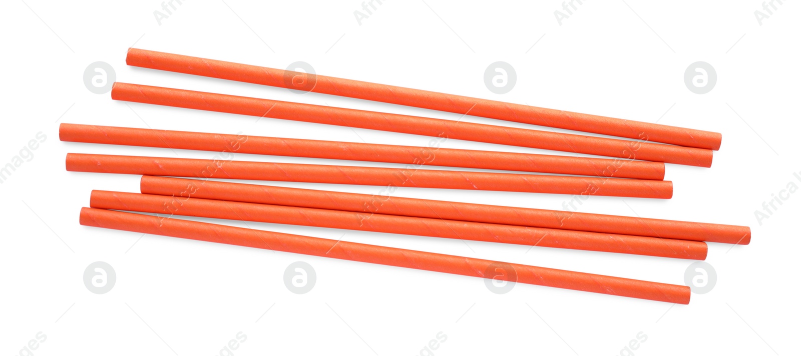 Photo of Orange paper cocktail straws on white background, top view