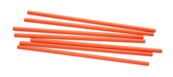 Orange paper cocktail straws on white background, top view