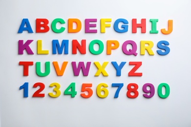Photo of Plastic magnetic letters and numbers isolated on white, top view