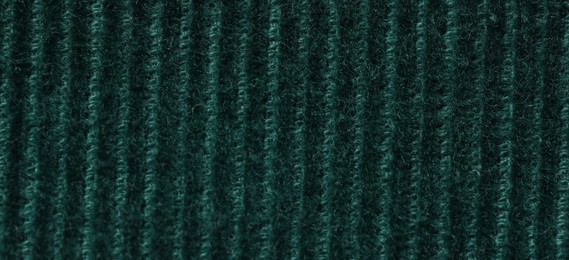 Photo of Texture of soft dark green knitted fabric as background, top view