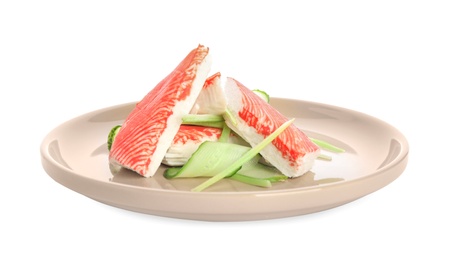 Photo of Plate with fresh crab sticks and cucumber isolated on white