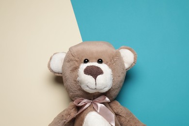 Photo of Cute teddy bear on color background, top view