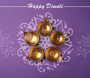 Image of Inscription Happy Diwali and clay lamps on color background, flat lay 