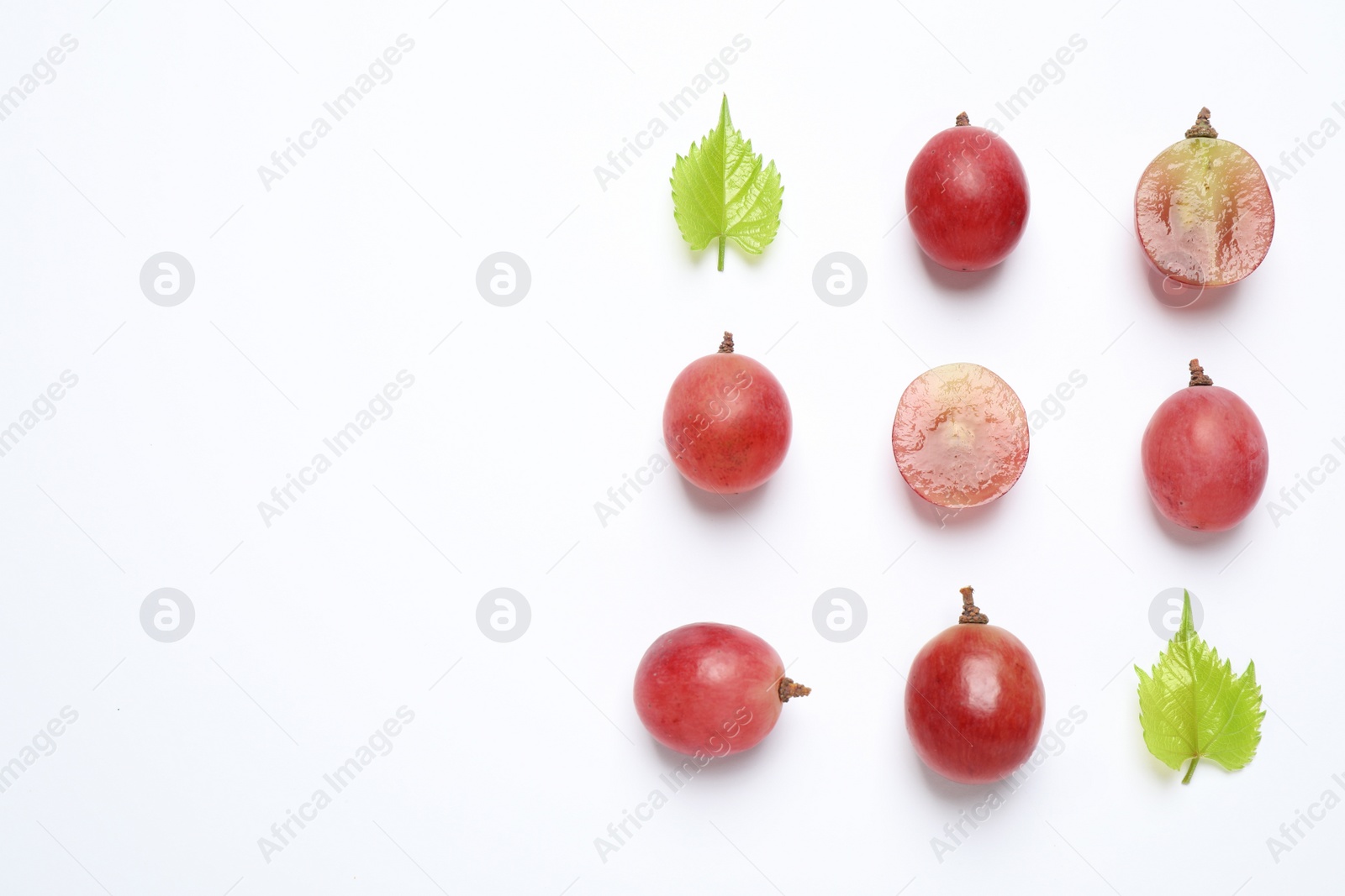 Photo of Composition with fresh ripe grapes and leaves on white background, top view