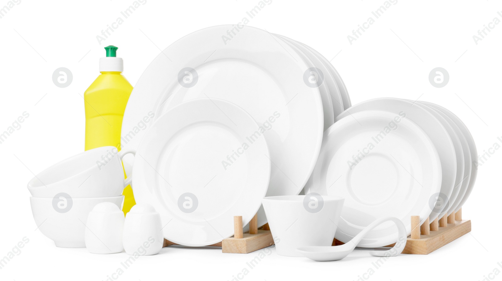 Photo of Clean dishware and bottle of detergent isolated on white