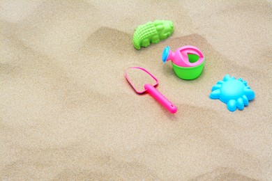Set of colorful beach toys on sand. Space for text
