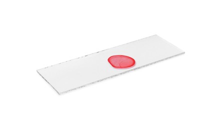 Photo of Microscope slide with sample of red liquid isolated on white