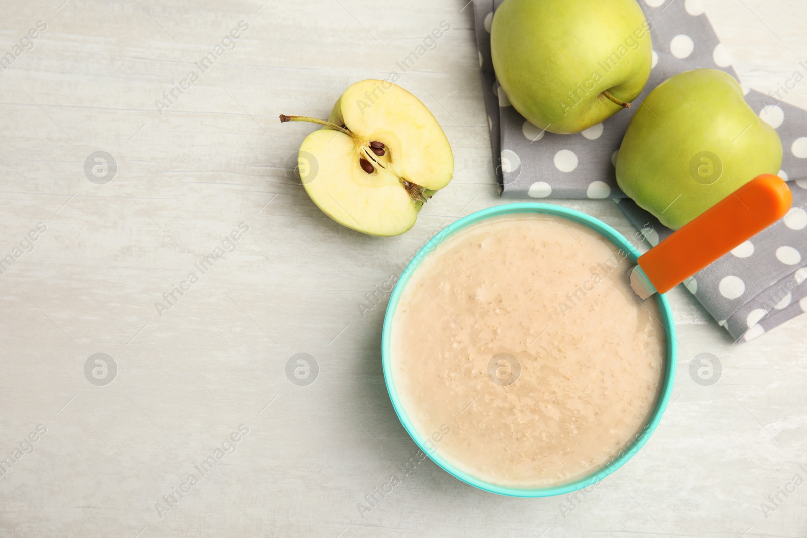 Photo of Flat lay composition with bowl of healthy baby food and space for text on light background