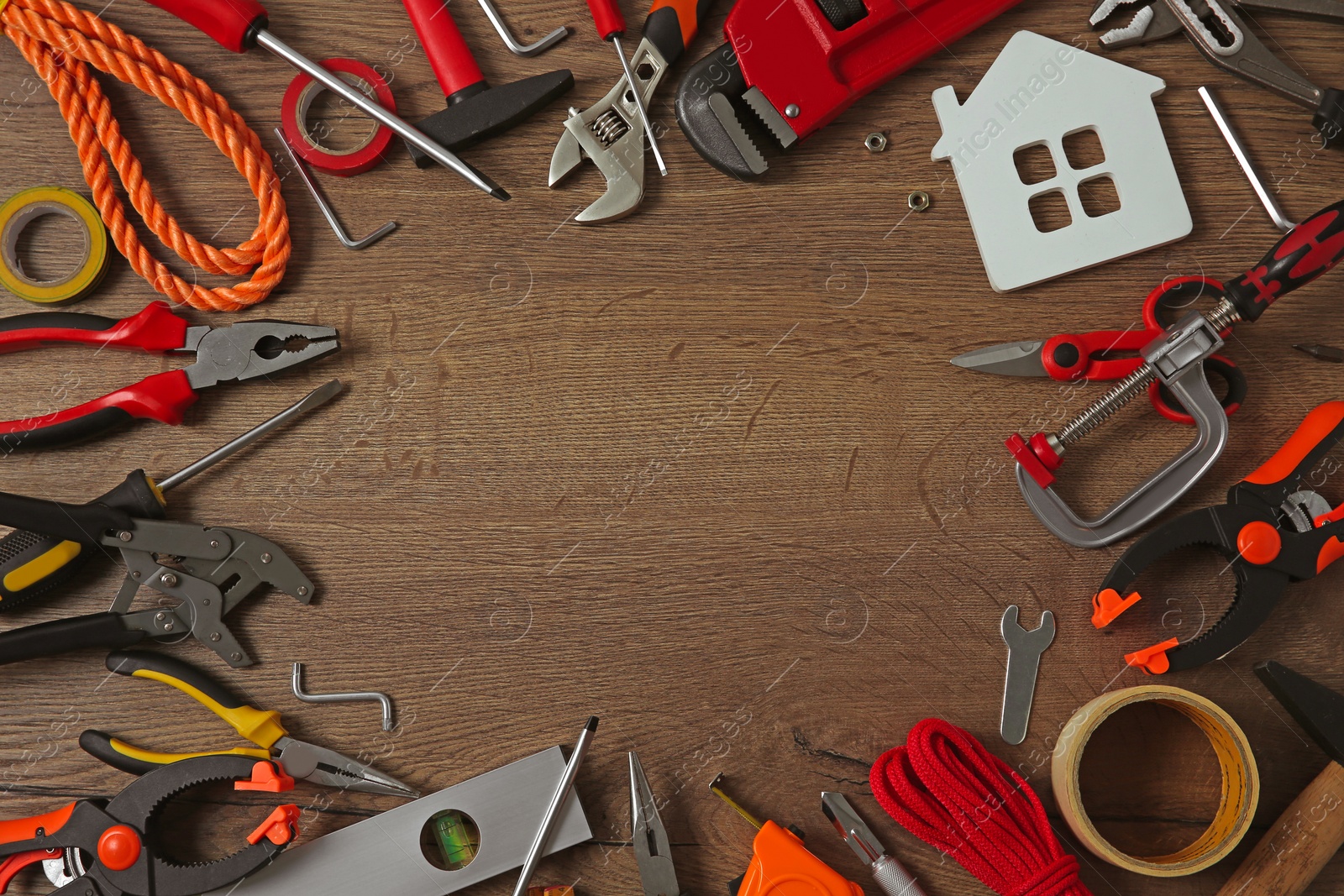 Photo of Frame made with repair tools on wooden table. Flat lay. Space for text