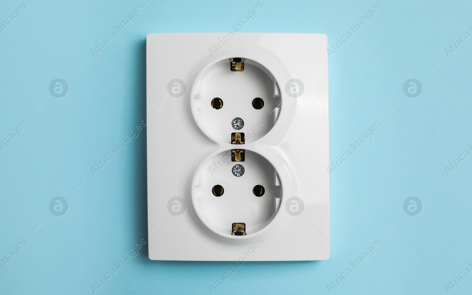 Photo of Double power socket on light blue wall. Electrical supply