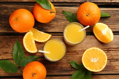 Photo of Orange juice and fresh fruits on wooden table, flat lay