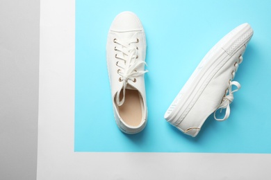 Photo of Stylish sneakers on color background, top view with space for text