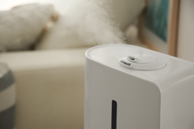 Modern humidifier indoors, closeup. Space for text