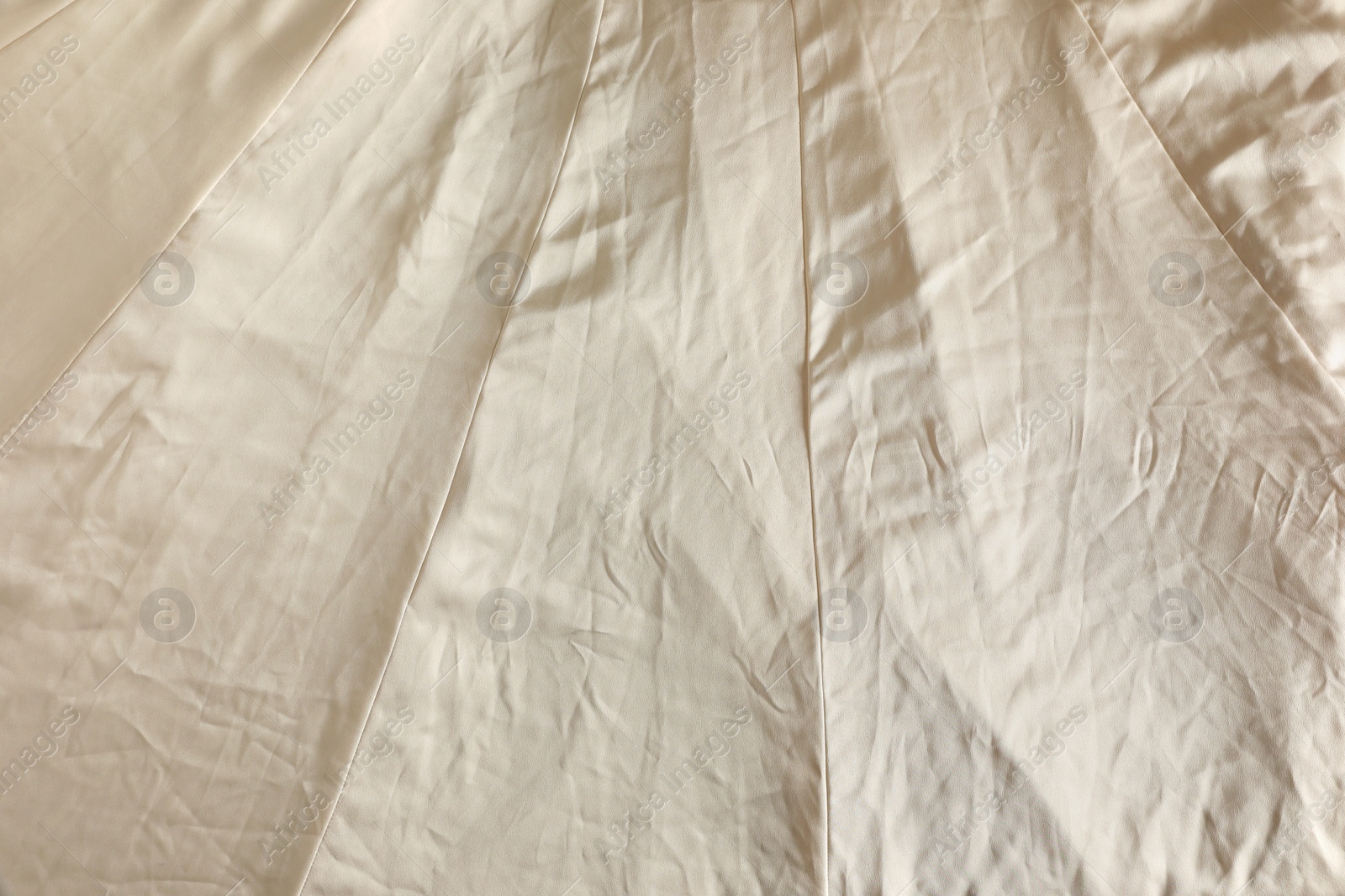 Photo of Crumpled dark beige fabric as background, top view