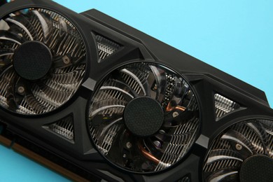 Photo of One graphics card on light blue background, top view
