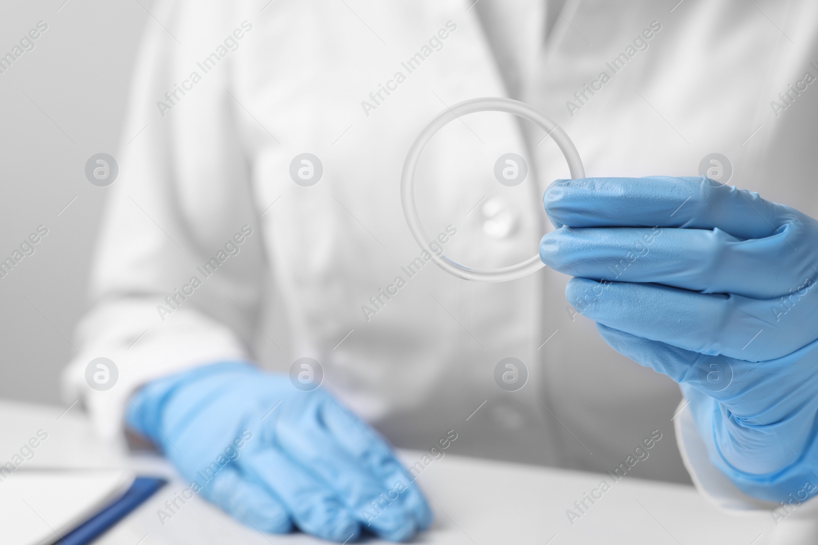 Photo of Doctor holding diaphragm vaginal contraceptive ring at table, closeup